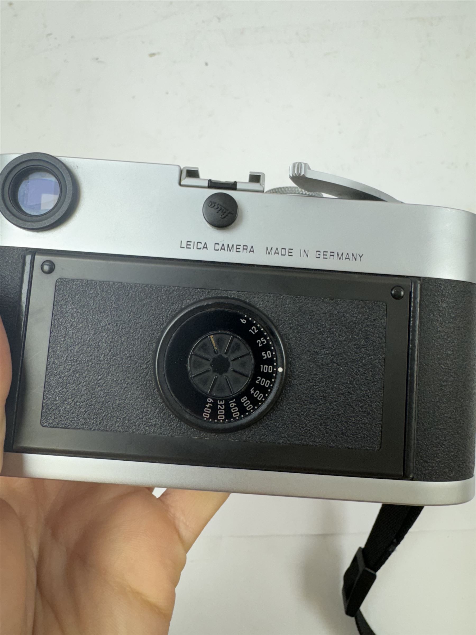 Leica MP 0.72 35mm film rangefinder camera body, in silver, chrome and black small grain leatherette finish, serial no. 2923784, made in Germany circa 2003, with Leica shoulder strap