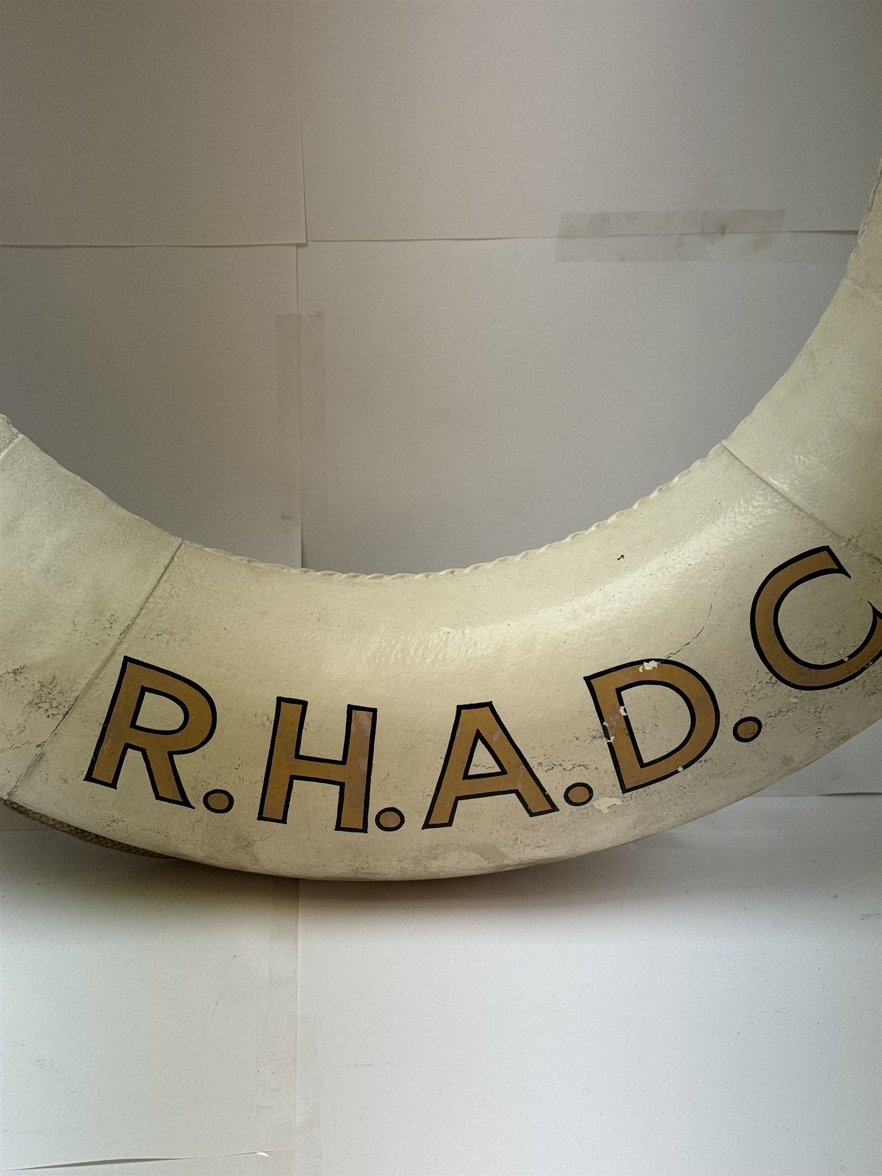 Four mid 20th century yacht lifebuoys, each painted in gold and black lettering 'Sarina R.H.A.D.C', upon a white ground, D68cm