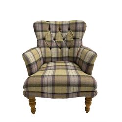 Traditional shaped armchair, upholstered in deep buttoned purple tartan fabric with red piping, raised on turned and tapering stained beech supports