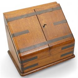 Edwardian oak correspondence box, the hinged sloping front enclosing a fitted interior incorporating a stationery rack, perpetual calendar, pen tray and two glass inkwells, H32cm x W40cm