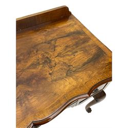 Mid-to-late 20th century figured walnut side table, raised back over figured top with cross banding and shaped front, fitted with three drawers, on cabriole supports with carved terminals 