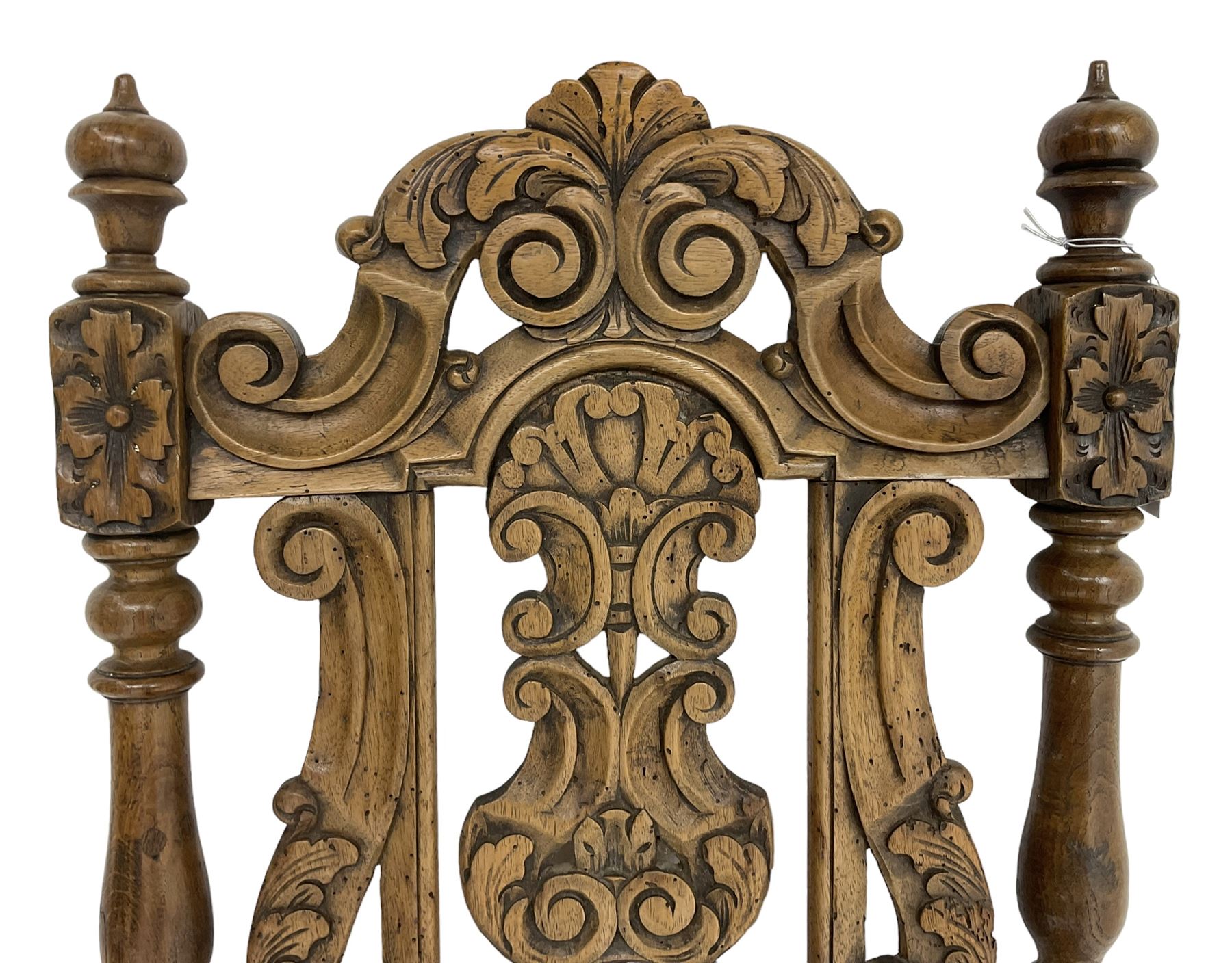 Carolean design oak high-back chair, the cresting rail carved with S-scrolls and foliage, the splat with a central flower head decorated with extending scrolls and acanthus leaves, upholstered seat, on turned and block supports united by S-scroll carved middle rail and turned stretchers