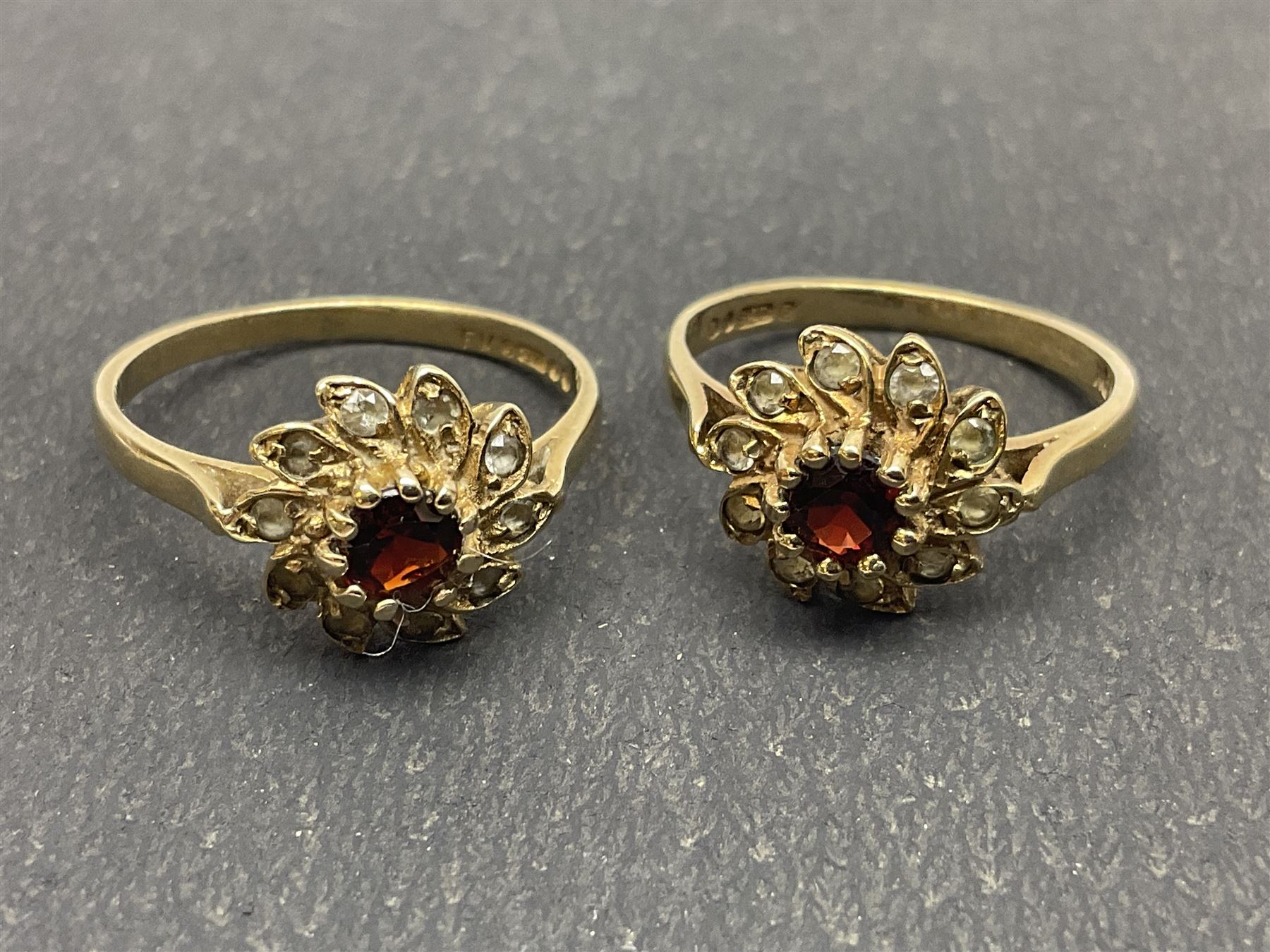 Two 9ct gold garnet and paste stone set cluster rings and a Early 20th century gold brooch, stamped 9ct