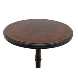 Early 20th century mahogany wine table, figured circular top with reeded edge, on turned and reed moulded stem, three reeded tapered supports on rectangular moulded pad feet 