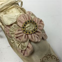 Pair of 19th century ivory silk satin ladies shoes, with rosette to the vamp, with pink silk satin heel, L23cm