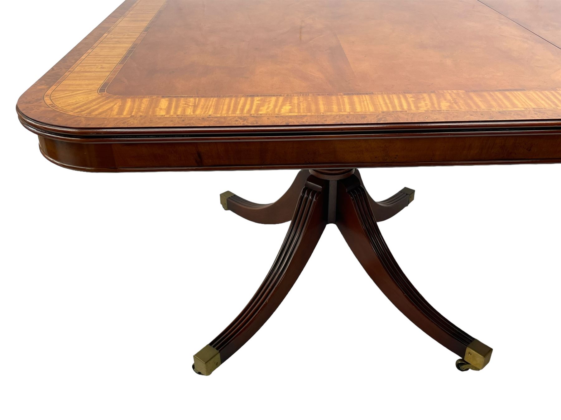 RBC Furniture (Made in England) - Georgian design mahogany dining table, rectangular top with rounded corners, satinwood and burr walnut bandings, two D-ends with two additional leaves and support rails, on barrel turned pedestals with four out-splayed reeded supports, brass cups and castors 