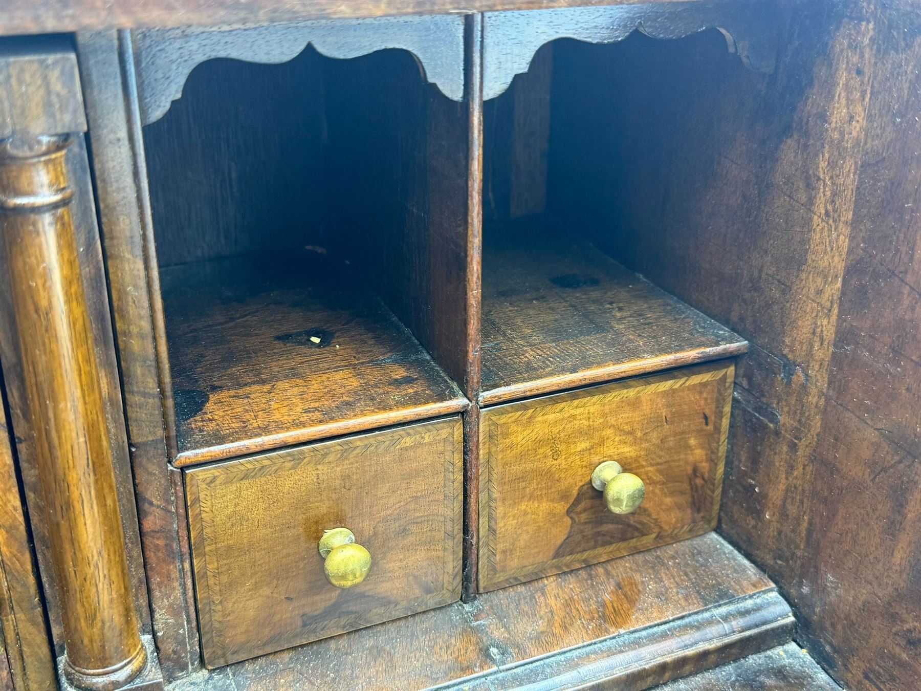 18th century walnut bureau, fall-front enclosing fitted interior with drawers and pigeonholes, over two short and two long drawers with brass escutcheon plates and handles, raised on bracket feet