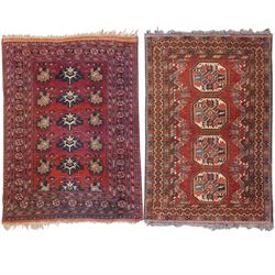 Afghan red ground rug, the field decorated with stylised plant motifs, within multiple bor...