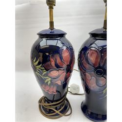 Pair of Moorcroft table lamps, in Anemone patter, upon a blue ground, with cream lampshades, H68