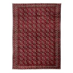 Turkman Bokhara red ground rug, the field decorated with rows of Gul motifs, within multip...