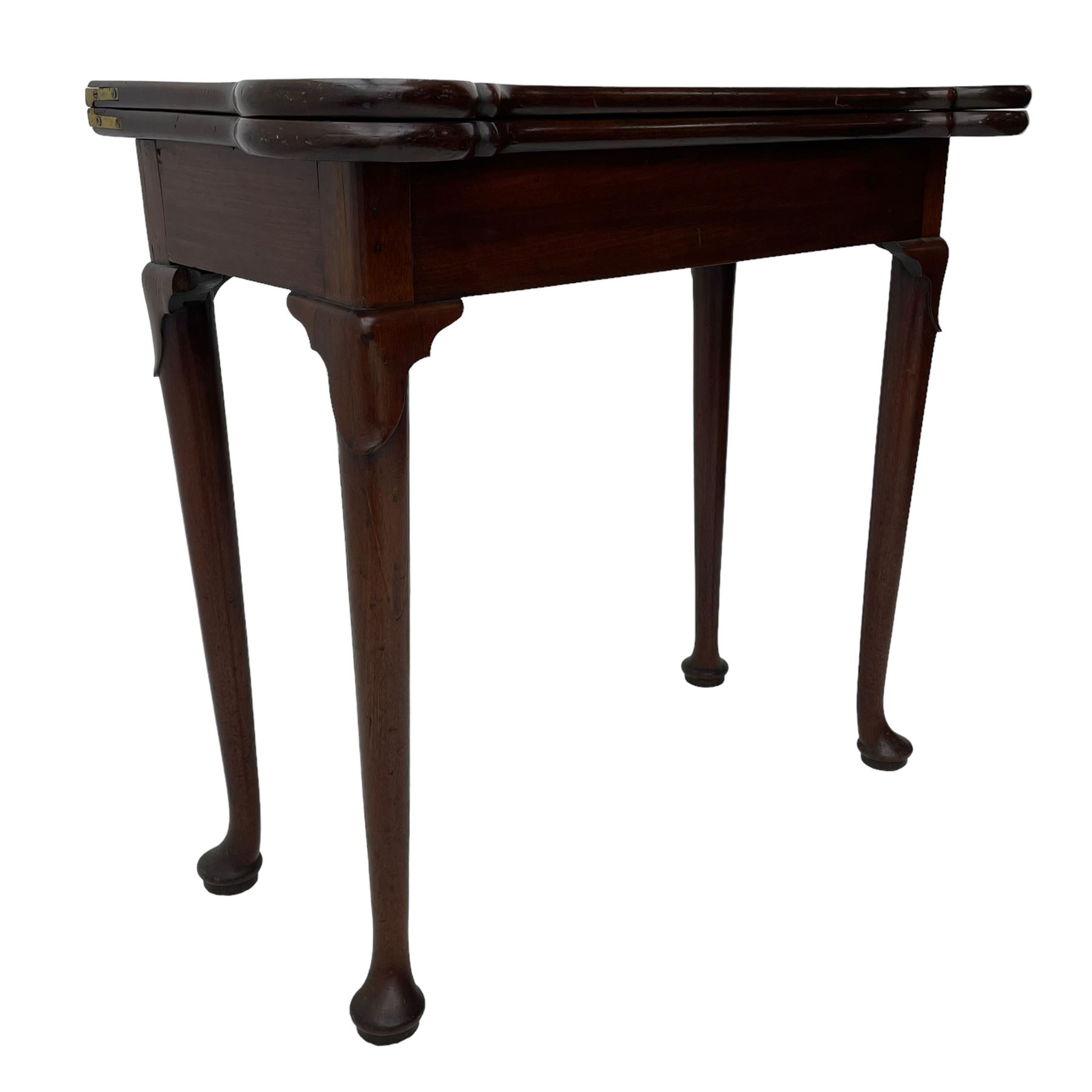 George III mahogany games table, the rectangular fold-over top with extending stepped rounded corners, opening to reveal baize lined interior with sunken counter wells, concertina action base, on lappet cabriole supports