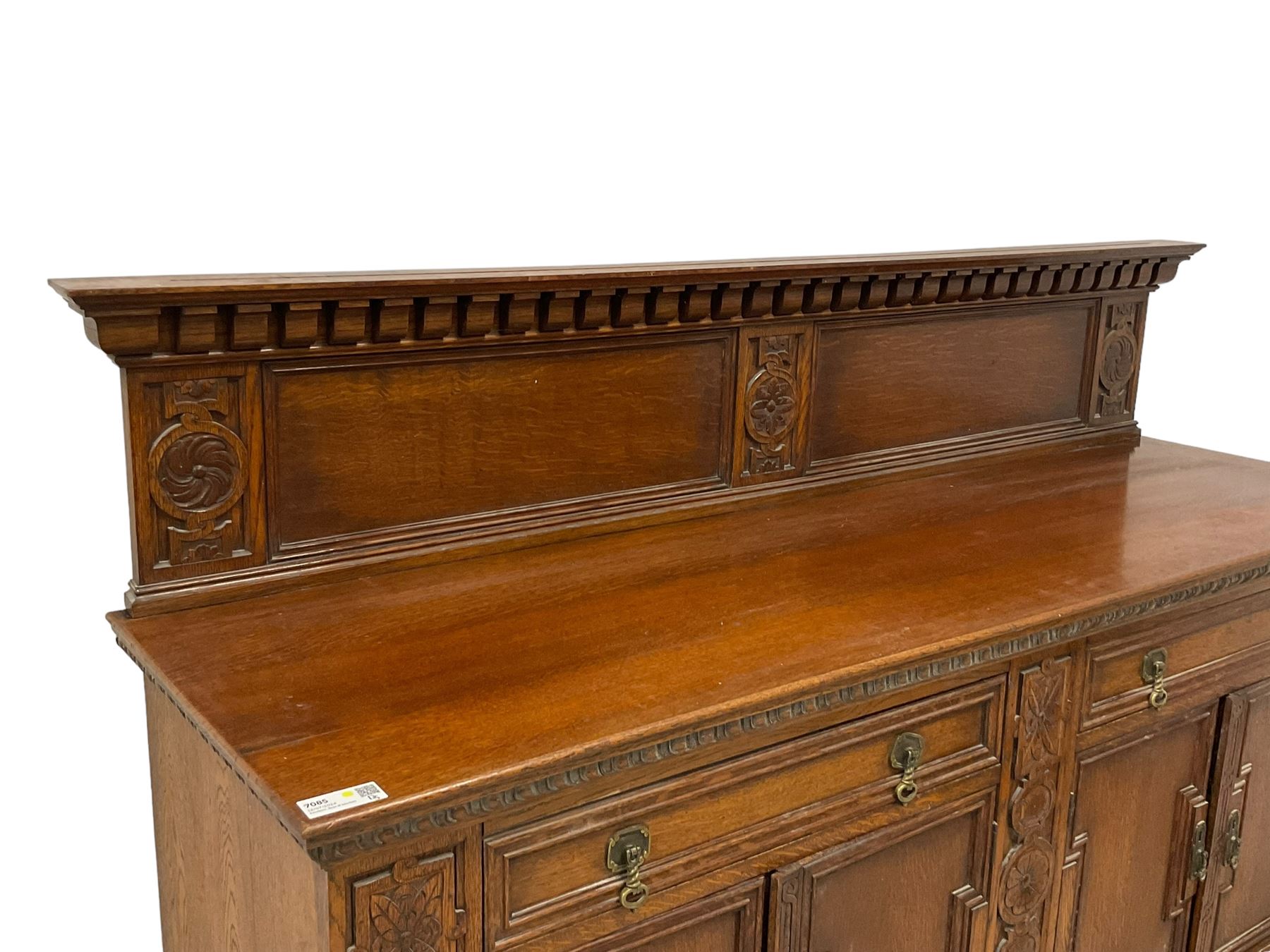 Early 20th century oak sideboard, raised panelled back with foliate carved decoration, rectangular top with gadrooned edge, fitted with two drawers over cupboards with field moulded facias, turned supports joined by stretchers