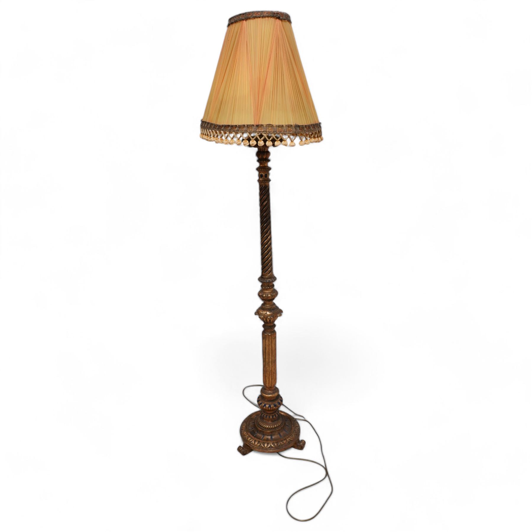 Neoclassical design gilt standard lamp, the turned ropetwist column decorated with egg-and-dart motifs and reeded elements, on circular base with scroll feet, with associated shade