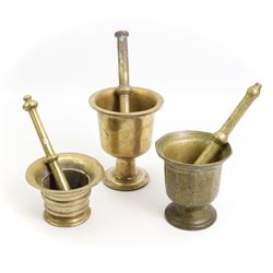 Three 19th century pestles and mortars, including a turned example with flared rim, an Eastern mortar with engraved decoration and pedestal foot, H16.5cm and one other (3)