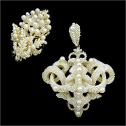 19th century seed pearl knot pendant brooch, of scrolling knot design suspended from a detachable matching bail, mounted to mother of pearl backing, together with a section designed as a bunch of grapes (2)