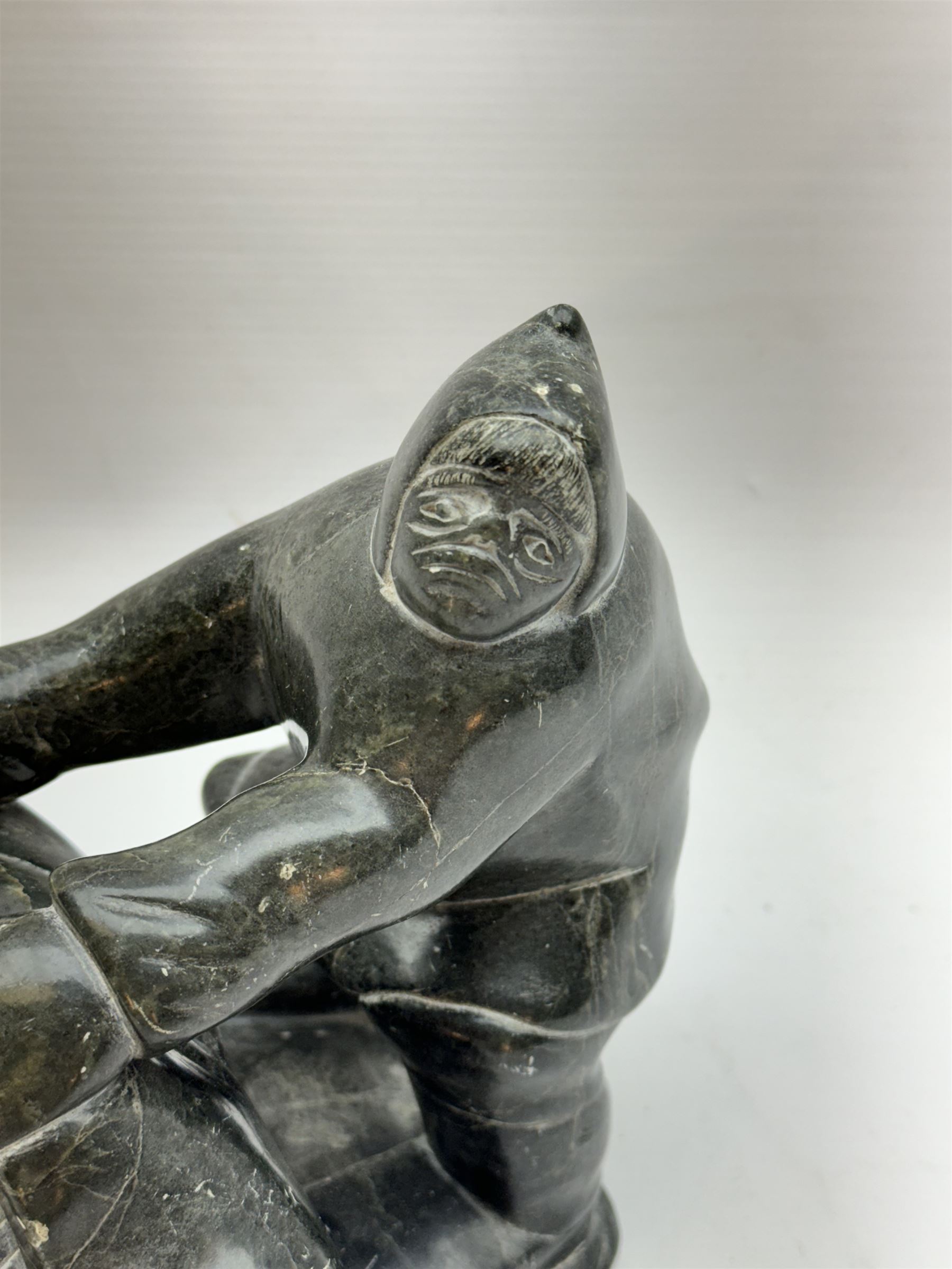 Inuit soapstone carving, of a hunter and a polar bear, circa 1960, H19cm 