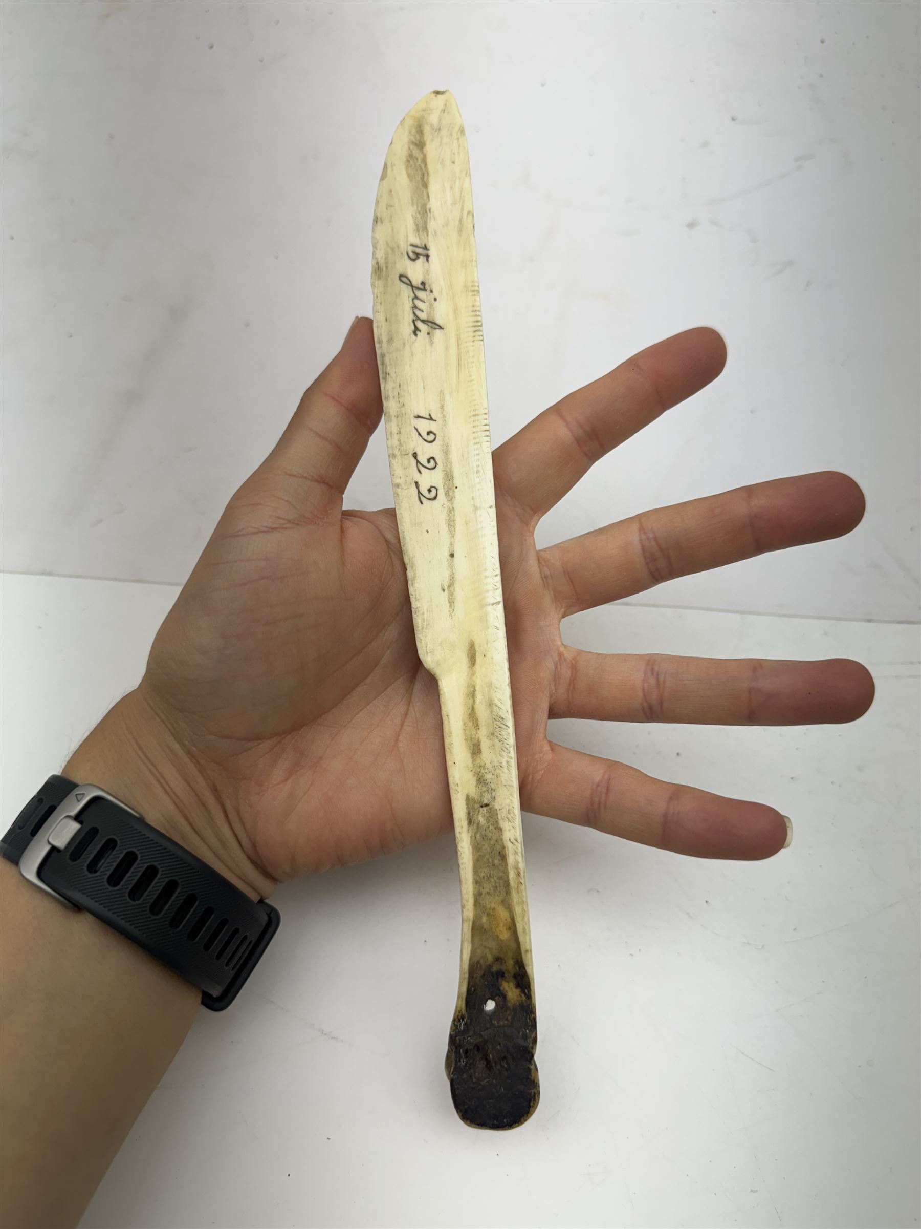 Inuit scrimshaw carved bone scraping knife, decorated with deer and tree, L25cm