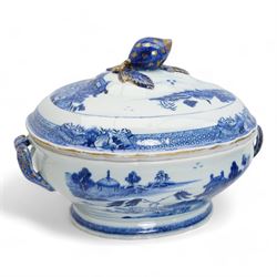 Pair of 18th century Chinese Export blue and white parcel gilt lidded tureens, each of twin handled oval form, decorated with buildings and landscape scenes within geometric and cell borders, with fruit finials, L33cm x H26cm approx.