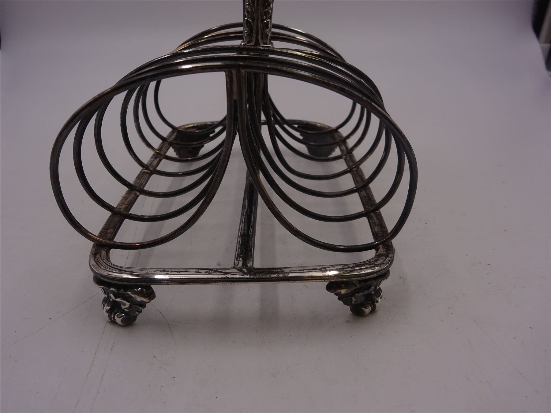 George III silver seven bar toast rack, with foliate mounted scroll feet and loop handle, hallmarked Matthew Boulton, Birmingham 1797, H15cm