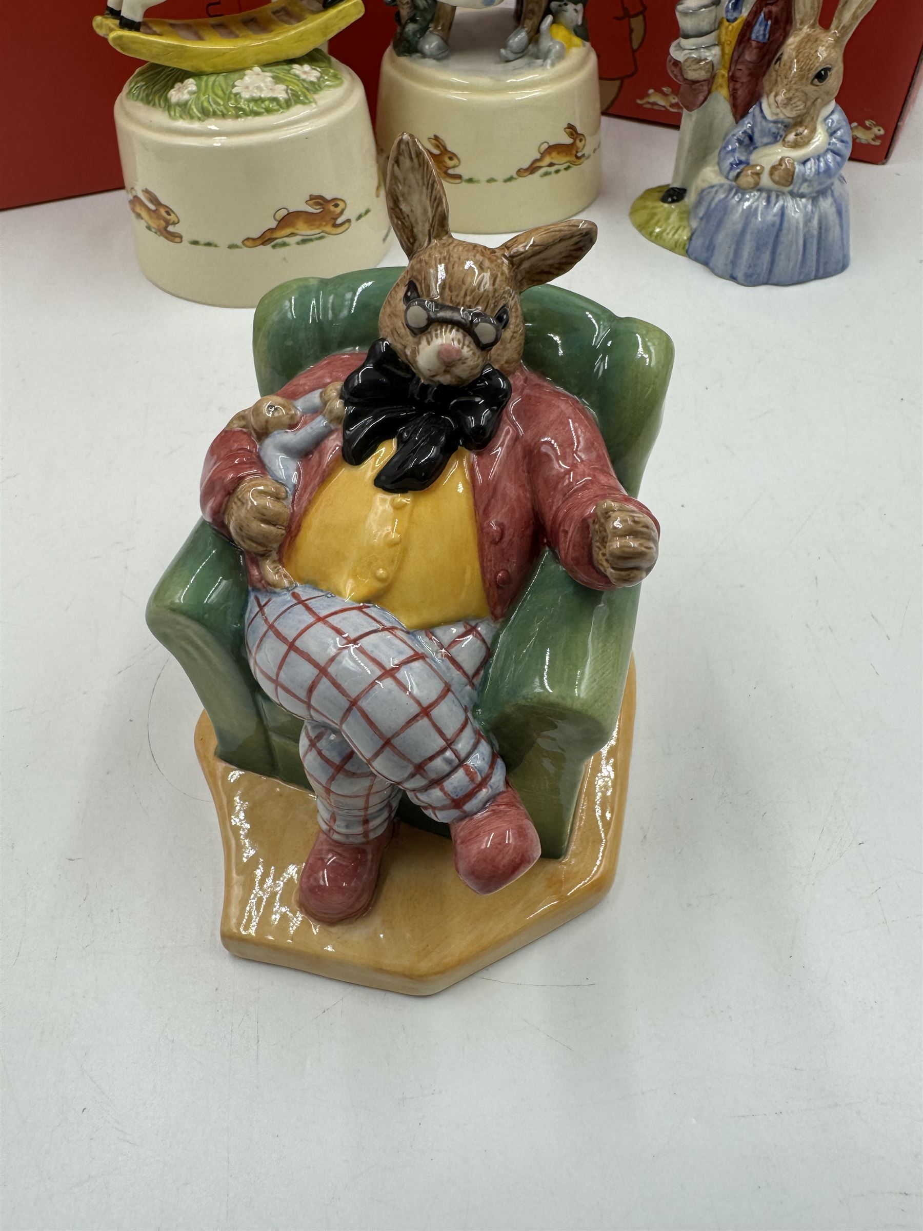 Two Royal Doulton Bunnykins music boxes, comprising Rocking Horse and Winter Waltz together with two Royal Doulton Bunnykins figures Once Upon a Time and Father, Mother & Victoria, all with original boxes  