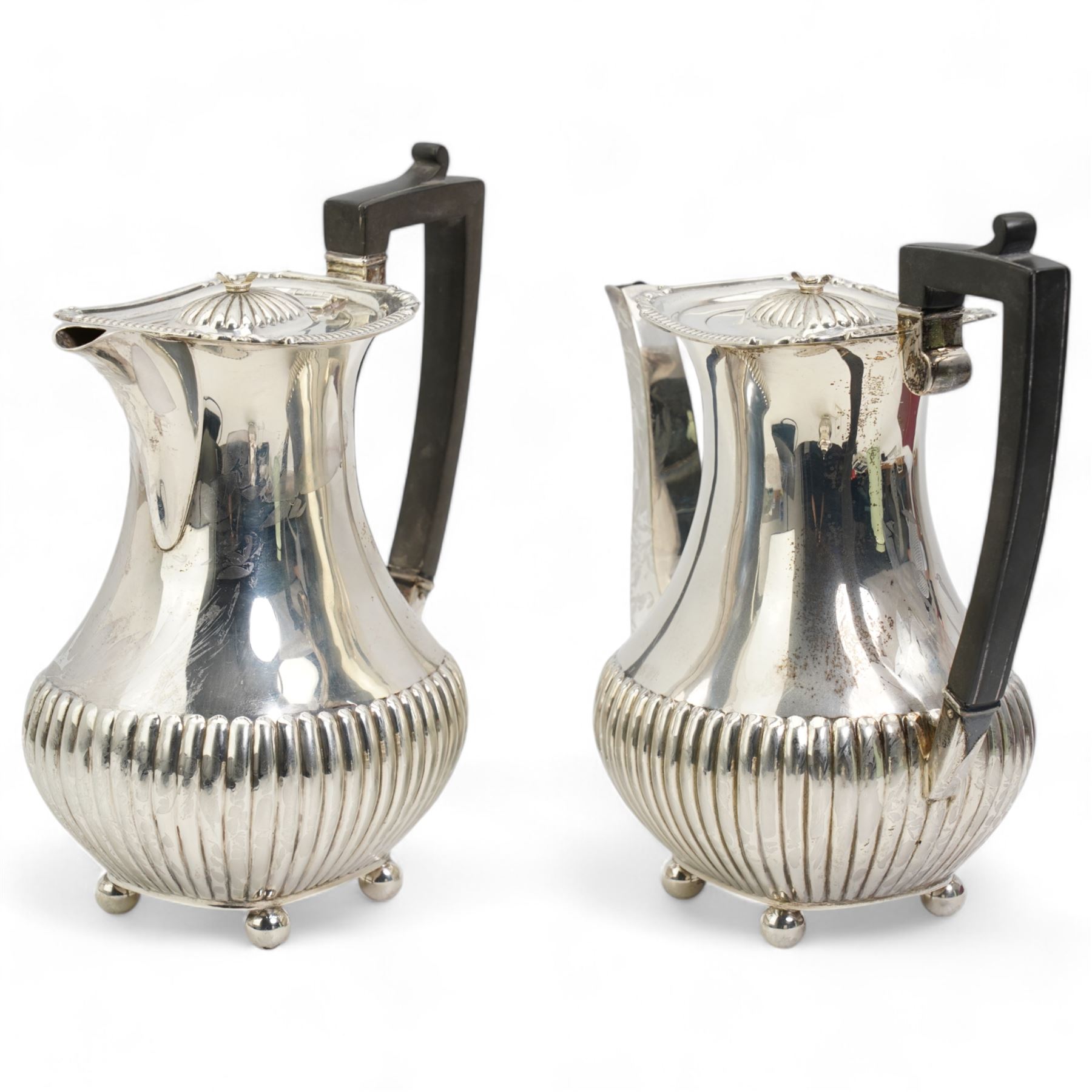 Silver three piece coffee set comprising coffee pot, hot water jug and sugar box each with half body fluted decoration, gadrooned edge, ebonised handles and ball feet, Sheffield 1927 Maker William Hutton & Son Ltd