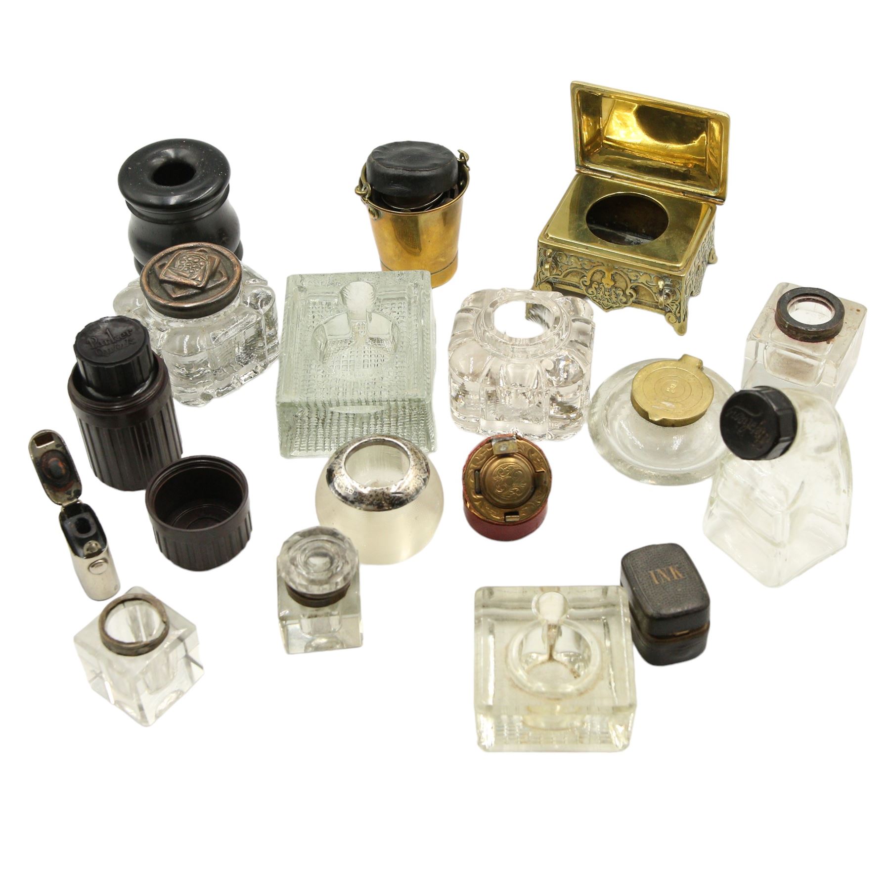 Victorian and later inkwells to include a brass casket form inkwell with hinged cover, a novelty inkwell in the form of a coal bucket with swing handle and leather covered inkwell, various glass examples, together with an early 20th century silver mounted match stick holder/ striker 