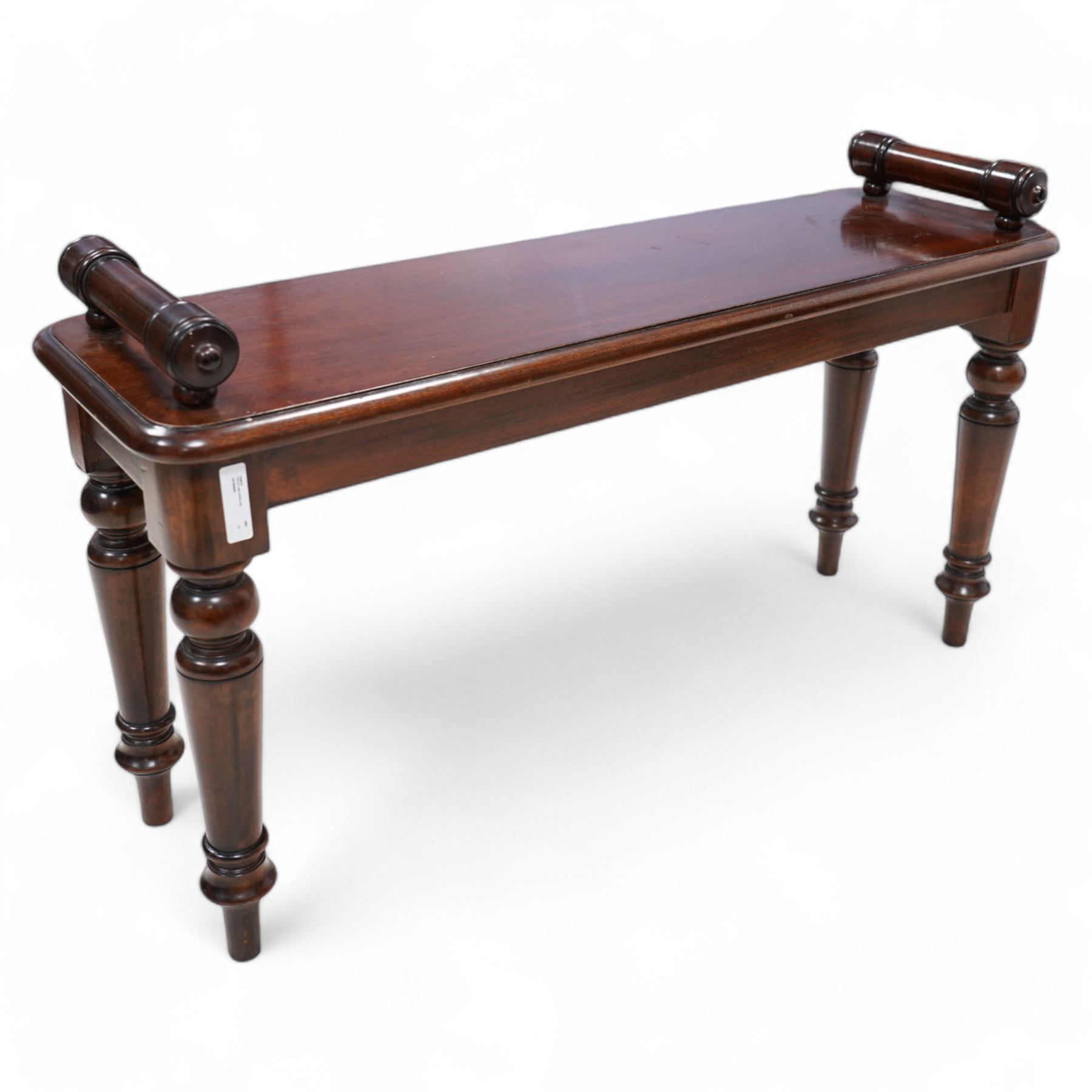 Victorian design mahogany hall bench or window seat, the moulded rectangular top mounted by turned bolster ends, on turned supports