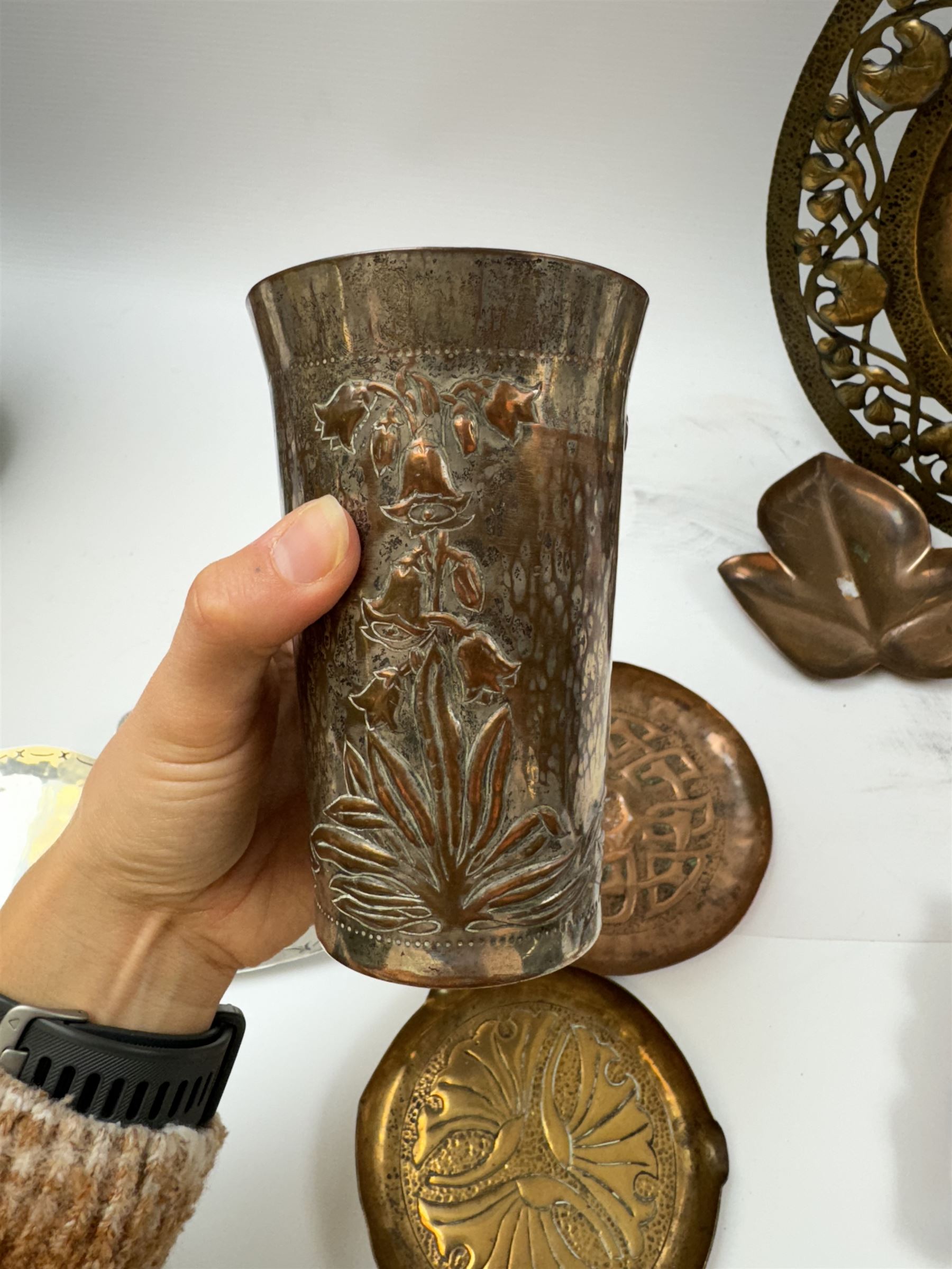 Keswick School of Industrial Arts, flared vase of cylindrical form, together with an Arts and Crafts plated copper, an embossed tray, copper dishes and charger 