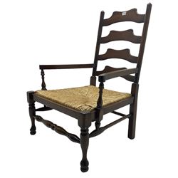 Oak low armchair, waived ladder back over rush seat, raised on turned  supports united by stretchers; together with matching stool