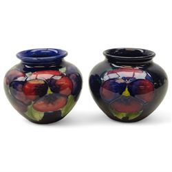 Two Moorcroft Pansy pattern baluster vases on blue ground, H7cm (2)