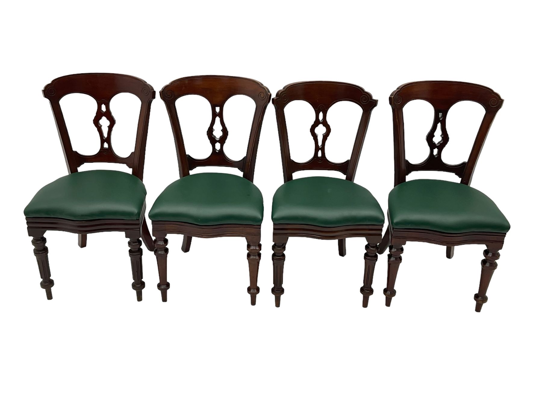 Matched set of twelve Victorian mahogany dining or boardroom chairs, the shaped cresting rail decorated with scrolled decoration, upholstered drop-on seats upholstered in green fabric, on turned supports  