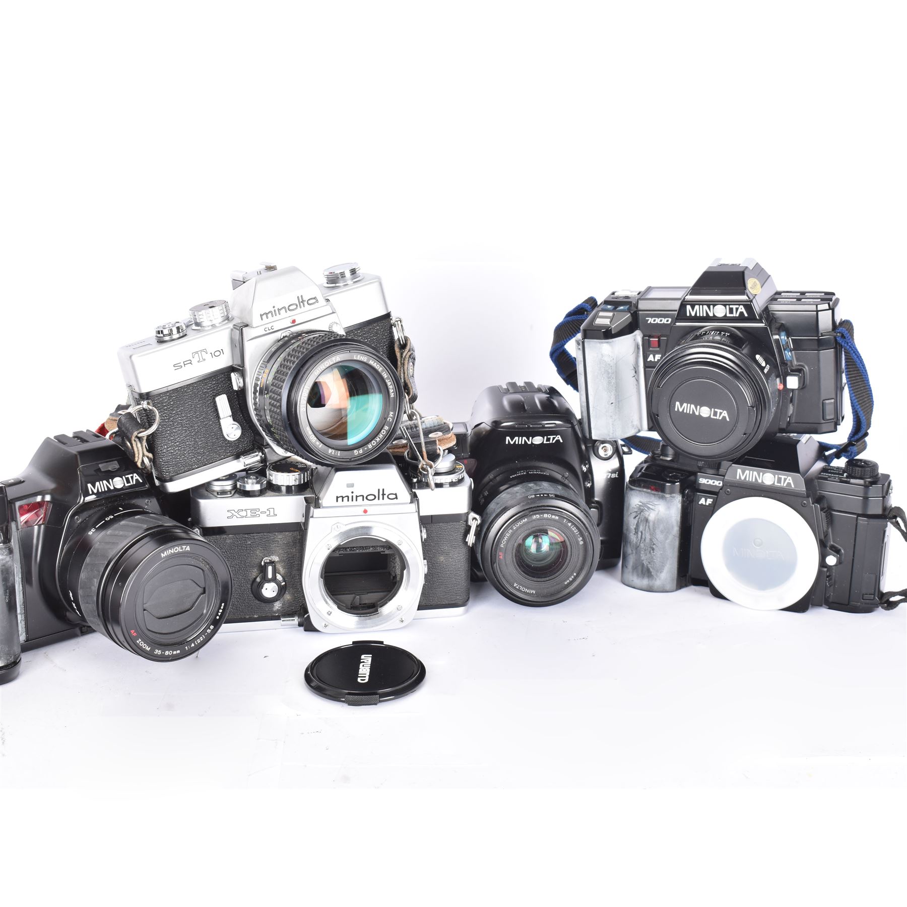 Six Minolta SLR camera bodies, comprising 7000 AF serial no. 12115735, with an AF 50mm 1:1.7 (22) lens serial no. 1148222, 9000 AF serial no. 13102736, 7700i serial no. 19314599, with an AF Zoom 35-80mm 1:4(22)-5.6 lens serial no. 19340884, 807si serial no. 57701857, with a AF Power Zoom 35-80mm 1:4(22)-5.6 lens serial no. 17108604, SRT 101 serial no. 3647794, with a MC Rokkor PG 1:14 f=50mm lens serial no.3192901, and an XE-1 serial no. 1087152