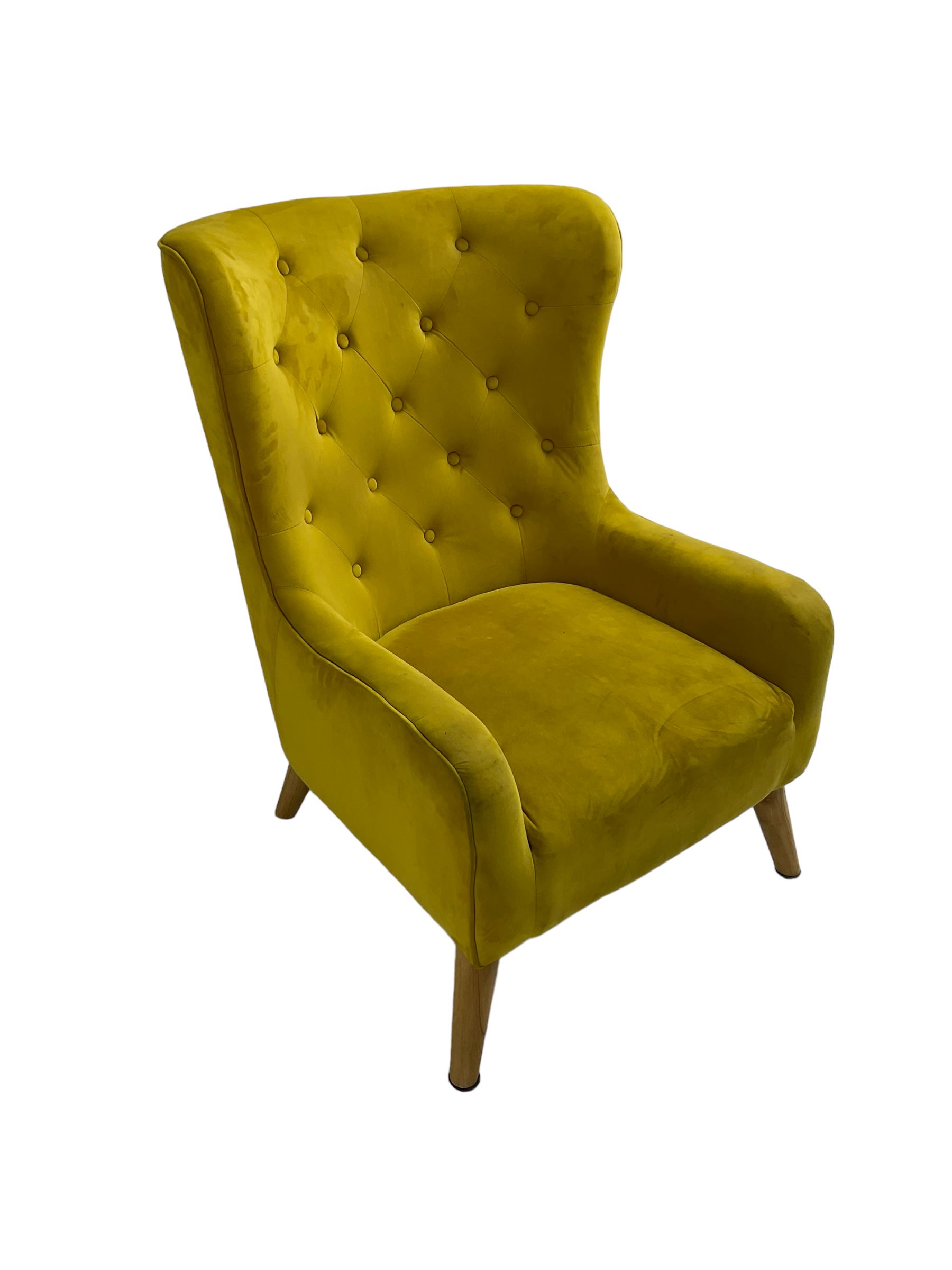 Mid-20th century design armchair, barrel back upholstered in buttoned mustard fabric, on tapering splayed front feet