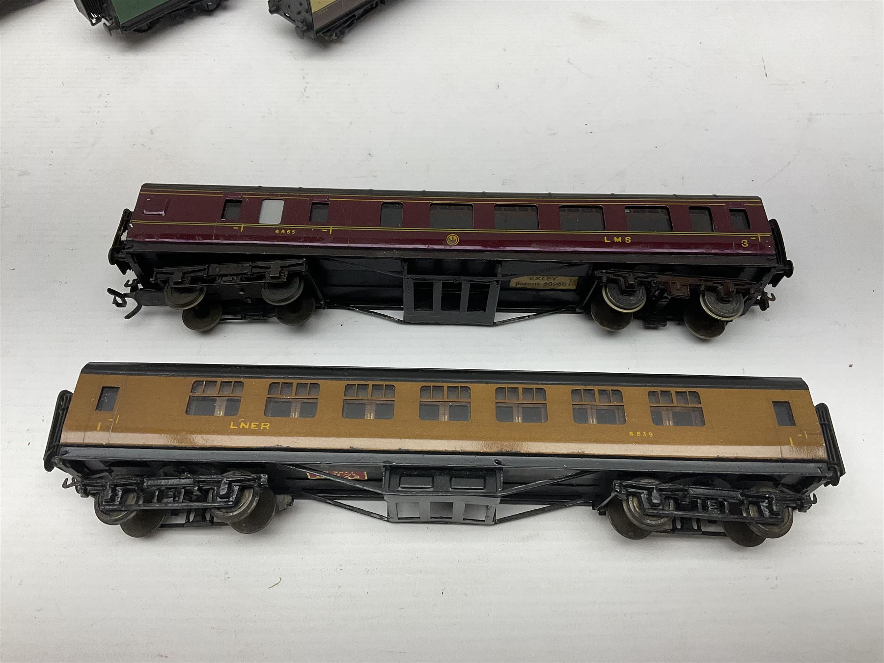 Exley '00' gauge - fourteen various coaches comprising four LMS maroon (3322 3rd, 2202 3rd, 6665 3rd and 388 Sleeping Car 3rd), LNER green/cream Buffet Car 21419, LNER teak 8639 1st, Southern green 6688 3rd, GWR brown/cream 3322 3rd, LNER 206 3rd, LNER 319 1st/3rd, SR green 351 3rd, SR green 188 Parcel Van, GWR 331 3rd and GWR 362 3rd; all unboxed (14)