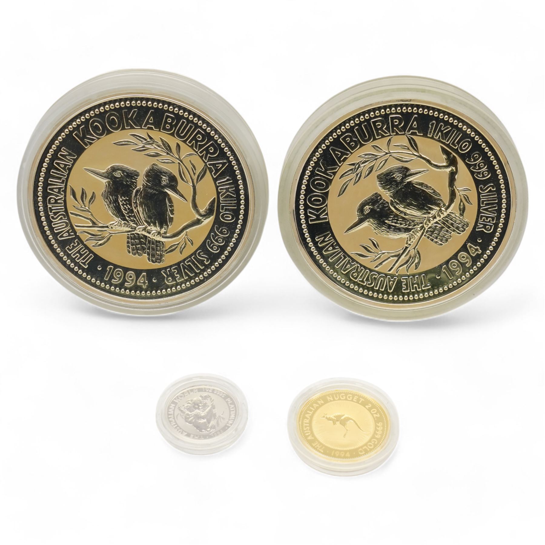 'The Aussie Australia's Diversified Precious Metal Portfolio' comprising two one kilogram fine silver kookaburras, two ounce fine gold kangaroo nugget and one ounce fine platinum koala, housed in a green plastic display case with certificates