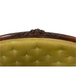 Victorian carved walnut framed two seat settee, cresting rail carved and moulded with a posy of roses and trailing foliate, over an oval back with scrolled arm terminals, serpentine fronted seat over cabriole supports with bell-flower carved knees, buttoned back and sprung seat upholstered in olive green fabric