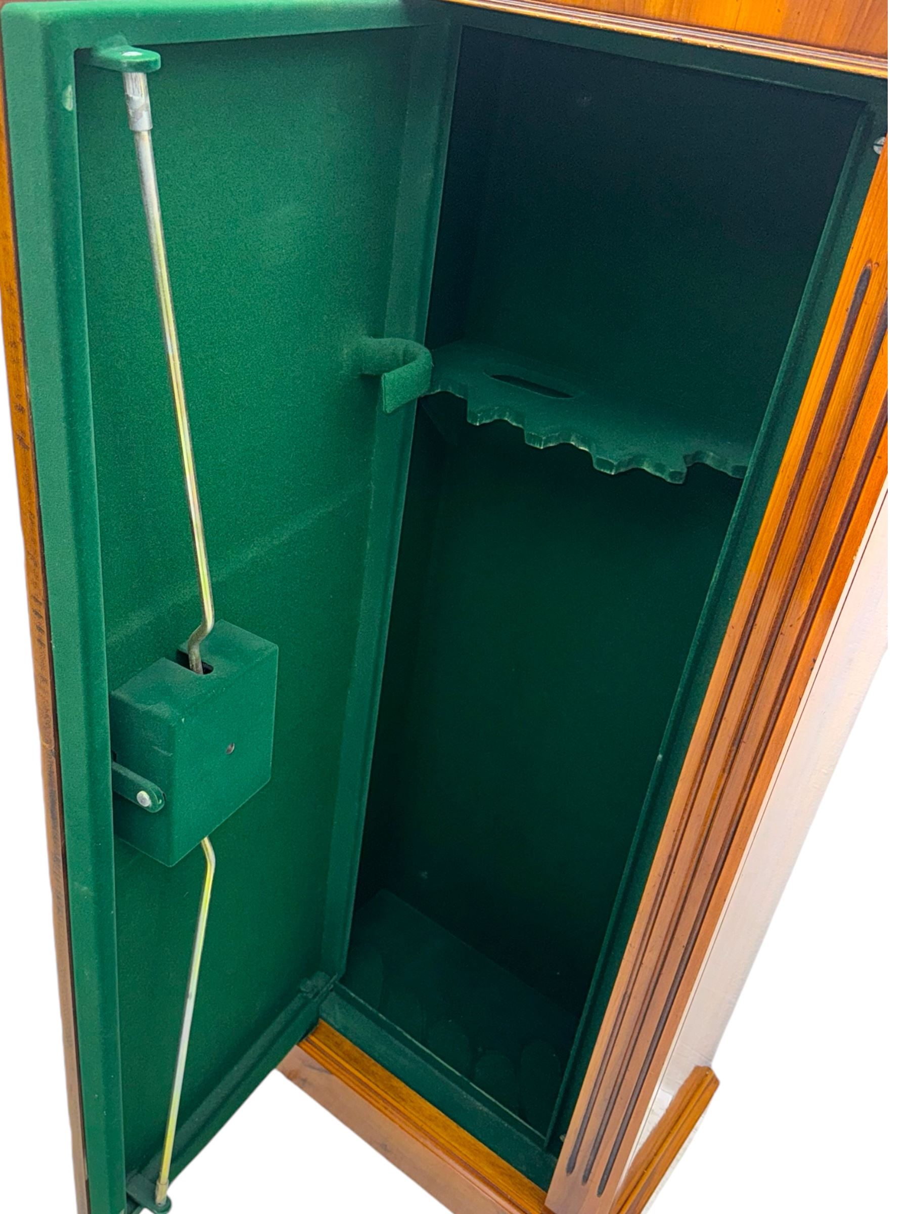 21st century steel lined gun cabinet, modelled as a Wellington chest of yew wood, to hold six long guns, interior lined with green baize, three storage shelves, with keys and bolts 