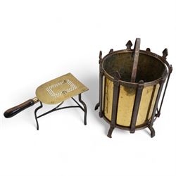 19th/ early 20th century wrought iron and brass coal bucket, of cylindrical form with gothic iron frame, upon five shaped supports, H36.5cm, together with a Georgian wrought iron and pierced brass trivet, with turned elm handle (2)