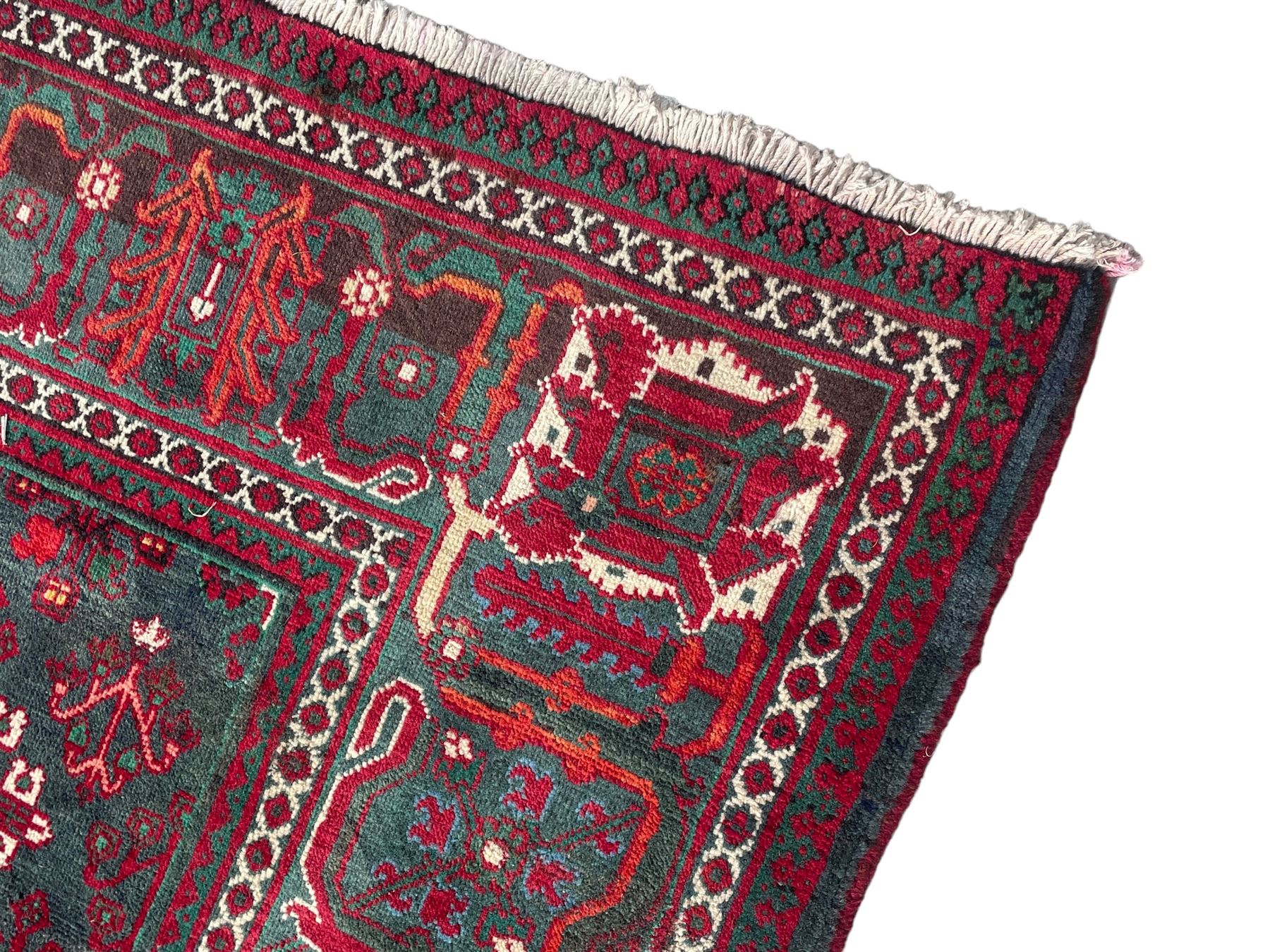 Persian Meymeh red ground rug, stepped lozenge medallion and spandrels, decorated all over with tree of life motifs, the main border decorated with repeating stylised plant motifs within geometric guard stripes 