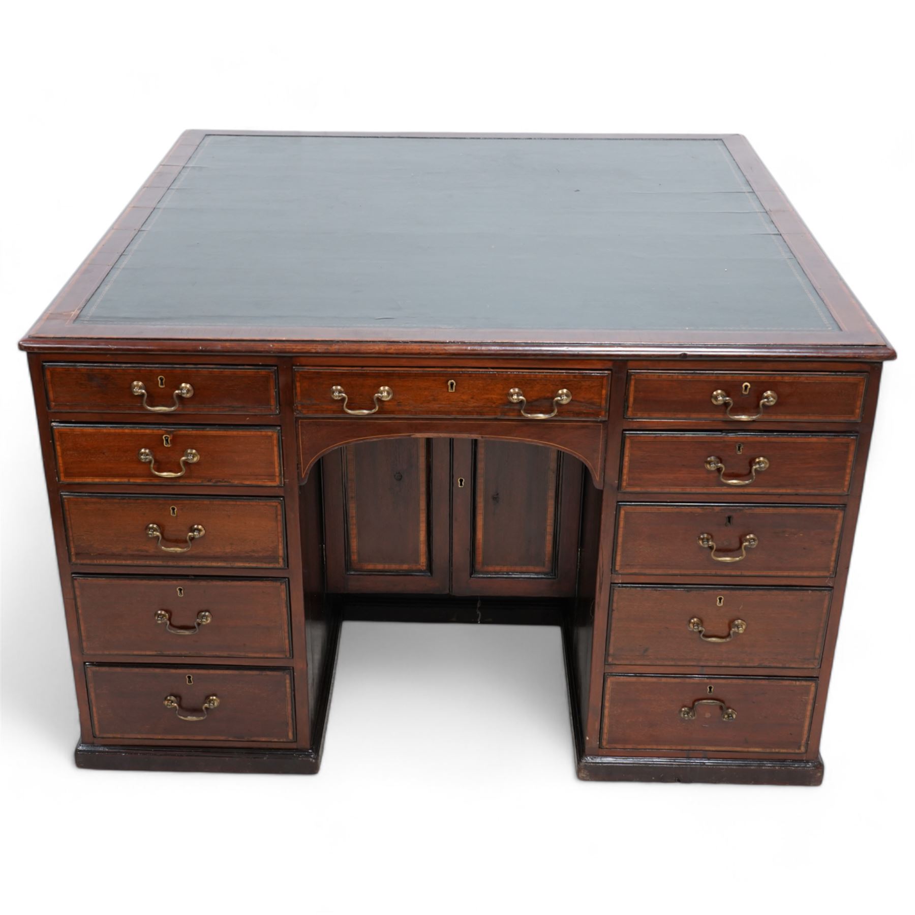 19th century inlaid mahogany kneehole desk, moulded rectangular top with inset leather writing surface and satinwood band, one side fitted with eleven drawers and panelled cupboard, the opposing side with kneehole fitted with eleven drawers and double cupboard, on skirted base with moulded edge 