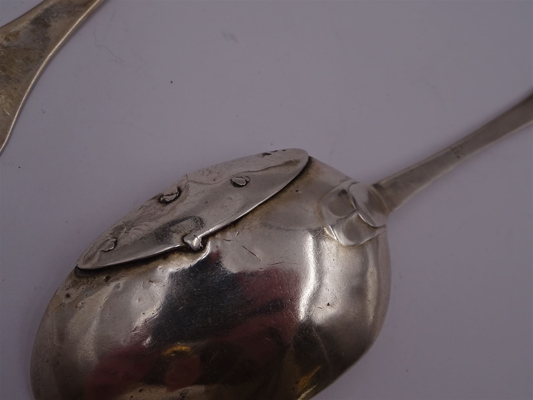 17th century silver trifid spoon, marks worn and indistinct, together with an Old English pattern silver spoon