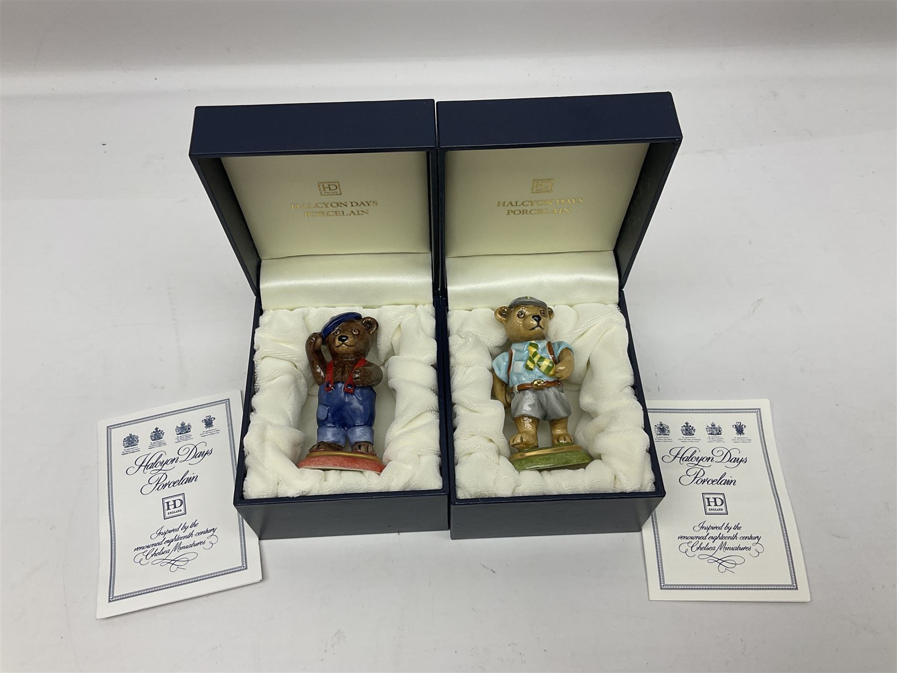 Eight Halcyon Days Teddy Bear of the Year figures, from 1993 to 2000, including one example modelled as a bear in Greek dress carrying a torch, one example modelled as a schoolboy and one example in a blue dress, all boxed 