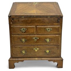 18th century walnut bureau, fall-front enclosing fitted interior with drawers and pigeonholes, over two short and two long drawers with brass escutcheon plates and handles, raised on bracket feet