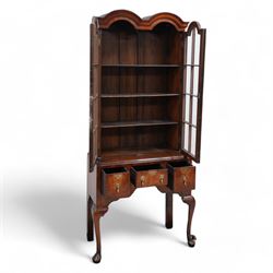 George II design walnut cabinet on stand, double arched top with applied mouldings over two astragal glazed doors, three internal shelves, the stand with moulded rectangular top fitted with three short drawers over shaped apron, on cabriole front supports 