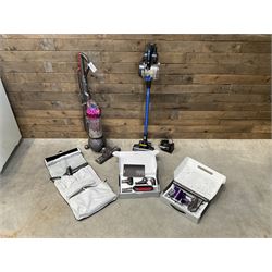 Dyson DC40 vacuum cleaner with various attachments, and a Vax cordless vacuum cleaner with single battery and charger