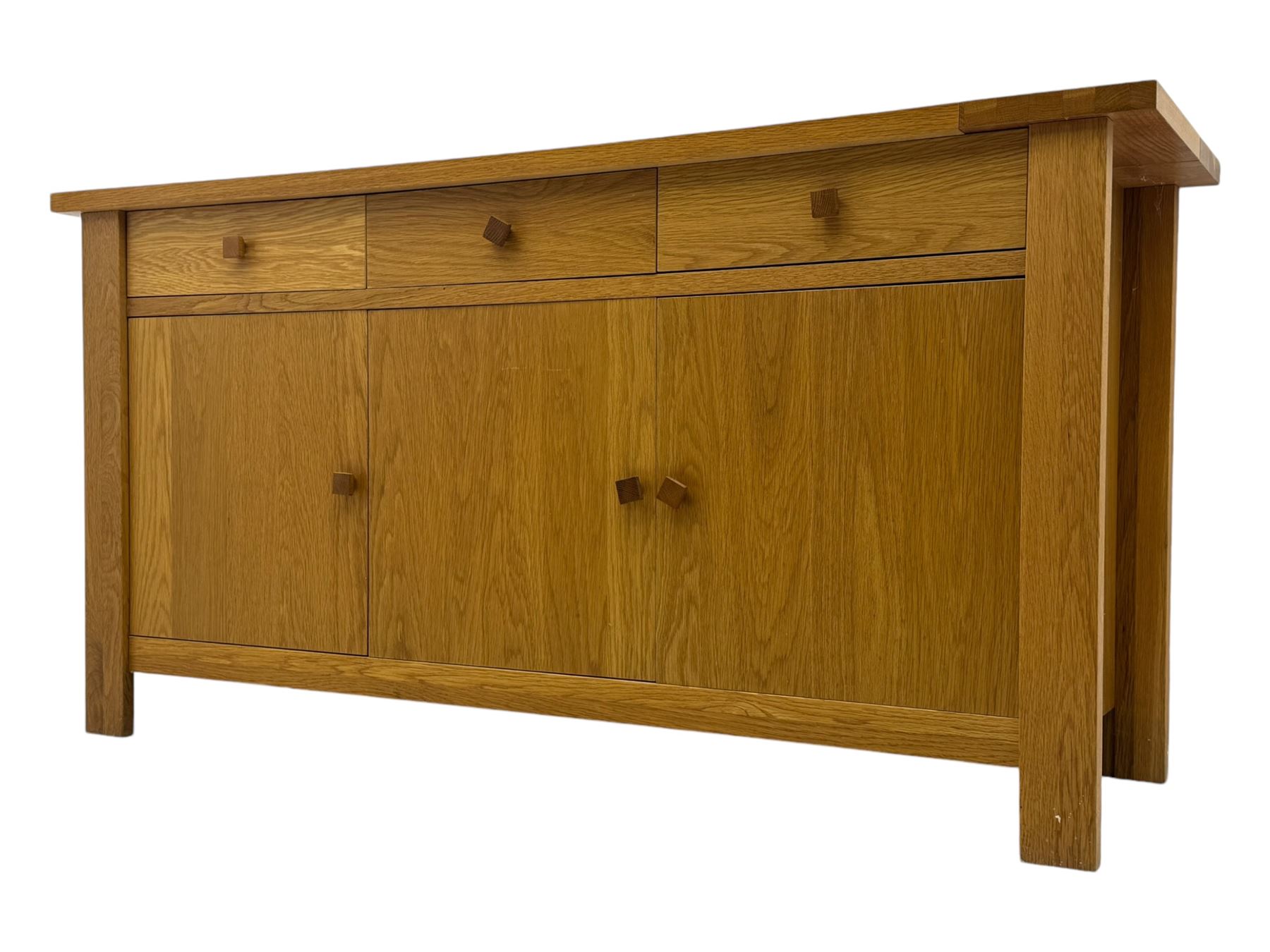 Contemporary oak sideboard, rectangular top with central contrasting plank, over three frieze drawers and three cupboards with enclosed shelving, on rectangular stile supports