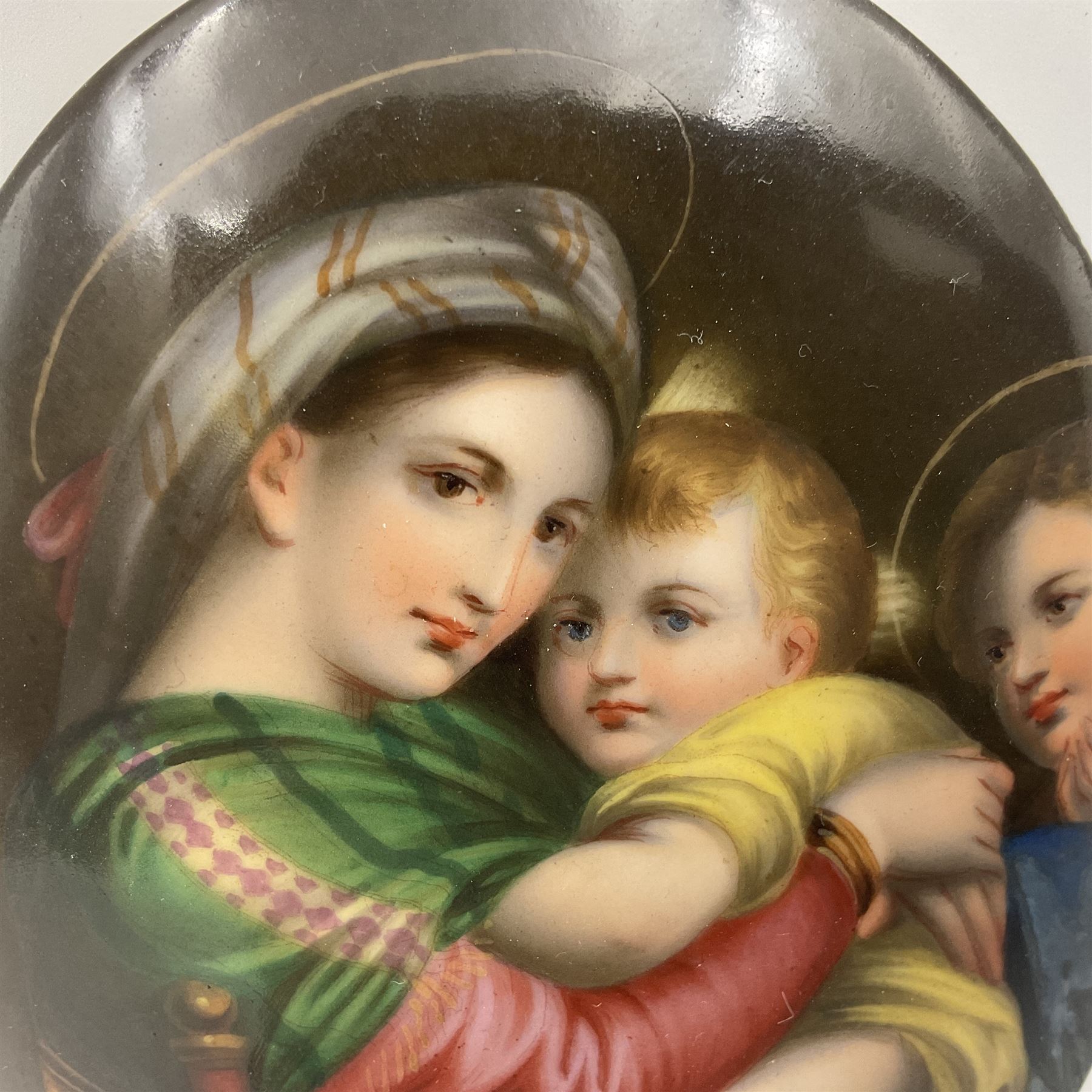 19th century Continental porcelain plaque, of oval form, painted with the Madonna and Child after Raphael, unmarked, possibly KPM, H12cm W9cm 