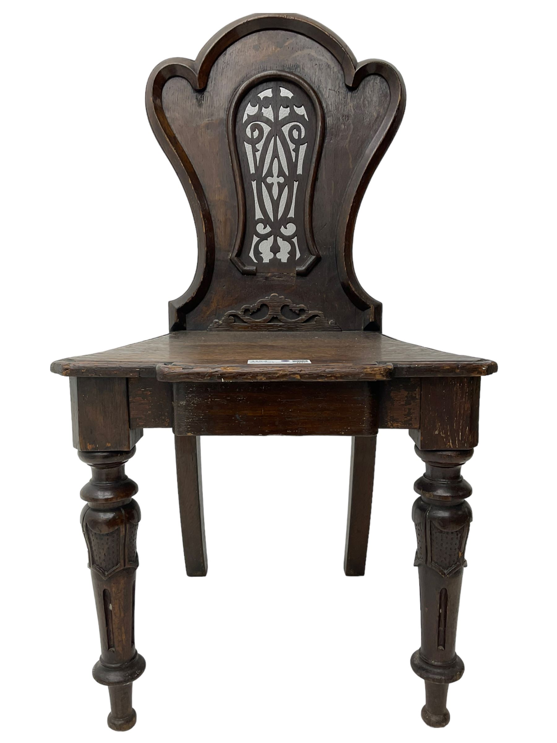 Victorian oak hall chair, the shaped back with fretwork splat, stepped moulded seat on turned lappet supports with fluting 