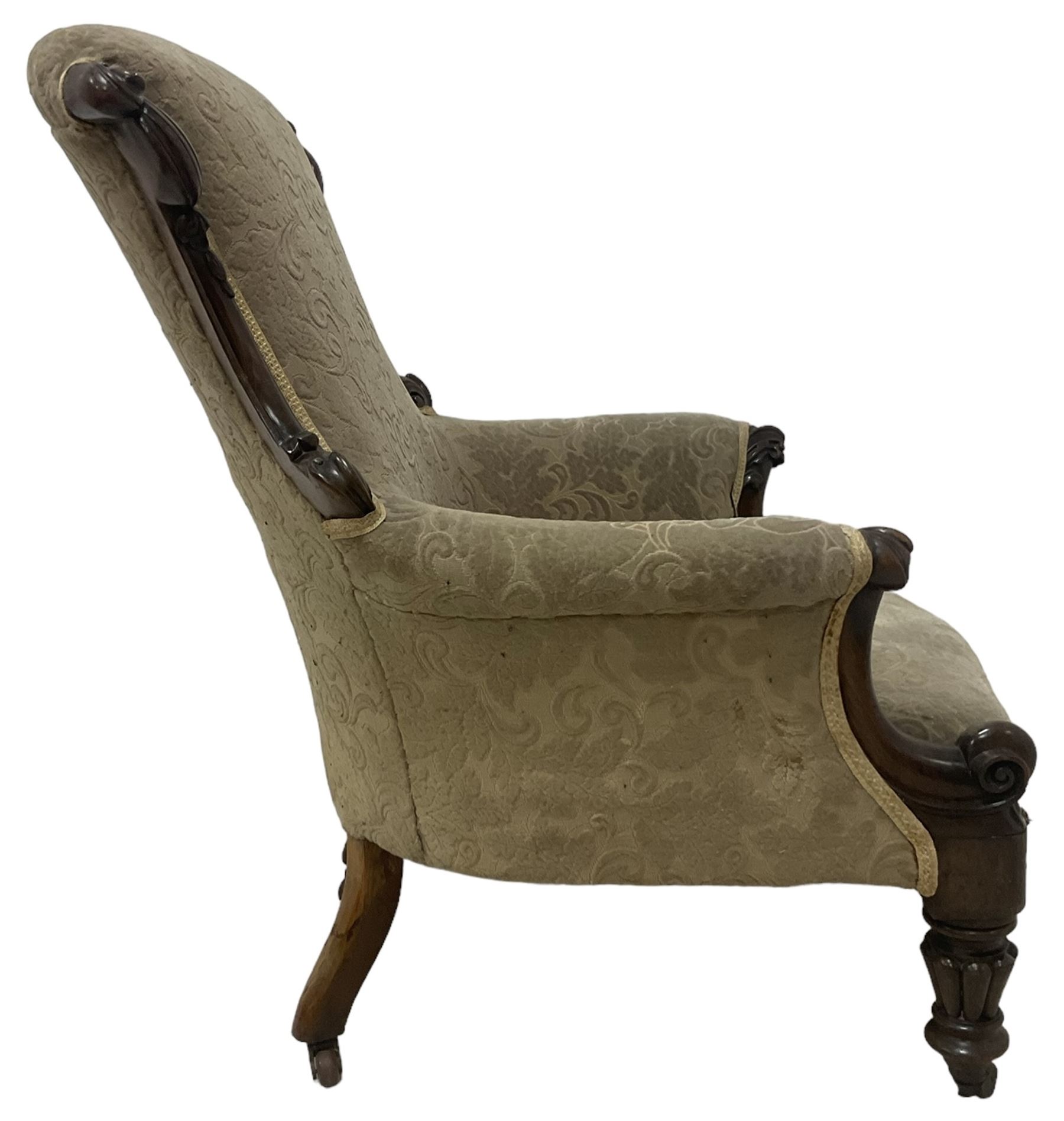 William IV mahogany framed armchair, rolled back with scroll carved uprights, acanthus carved arm terminals over serpentine fronted seat, raised on turned and lobe carved supports with castors