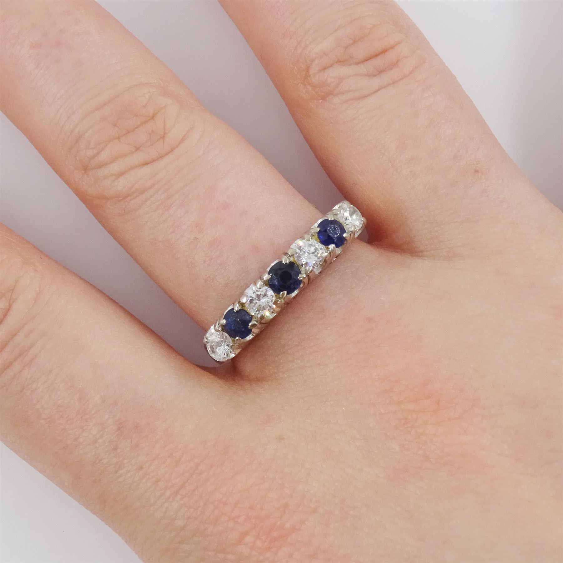 Gold and silver seven stone round brilliant cut diamond and sapphire ring, total diamond weight approx 0.40 carat